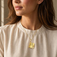 Illustrative natural lifestyle view of the gold heart notebook pendant engraved with My Little Ava
